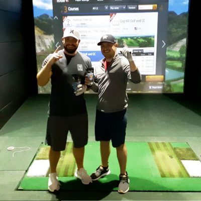 Two men enjoying our indoor golf